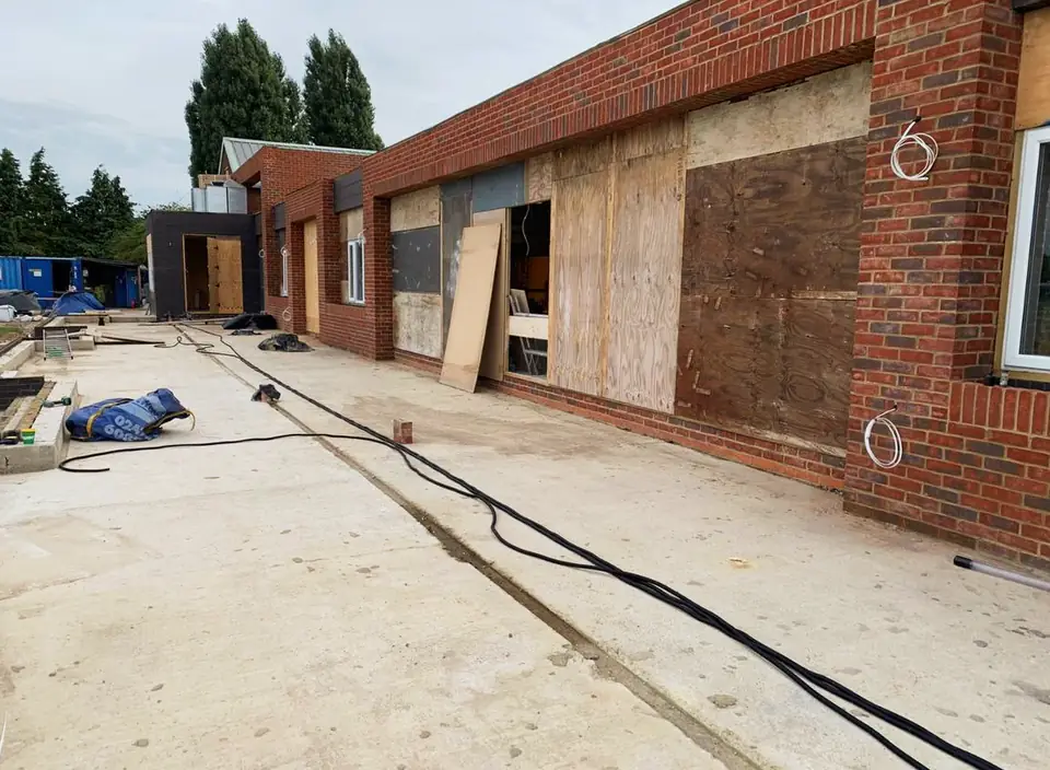 Decking area being prepared outside a new brick building, London project