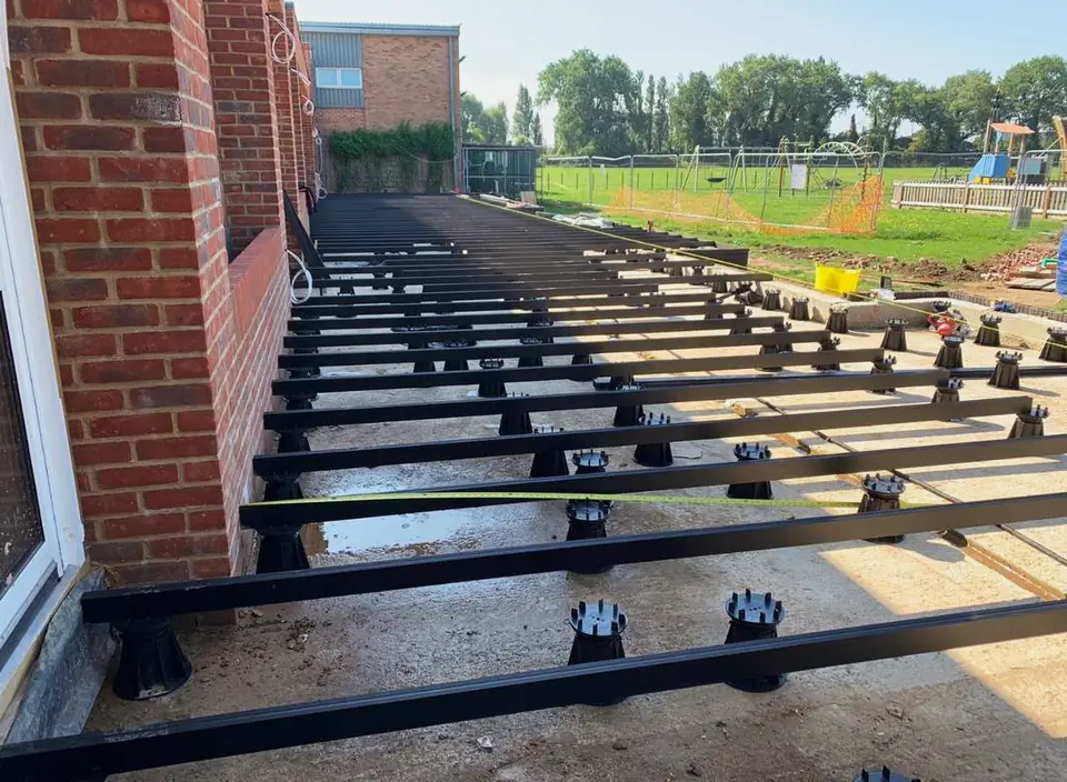 Decking subframe on adjustable pedestals before the boards go down, London project