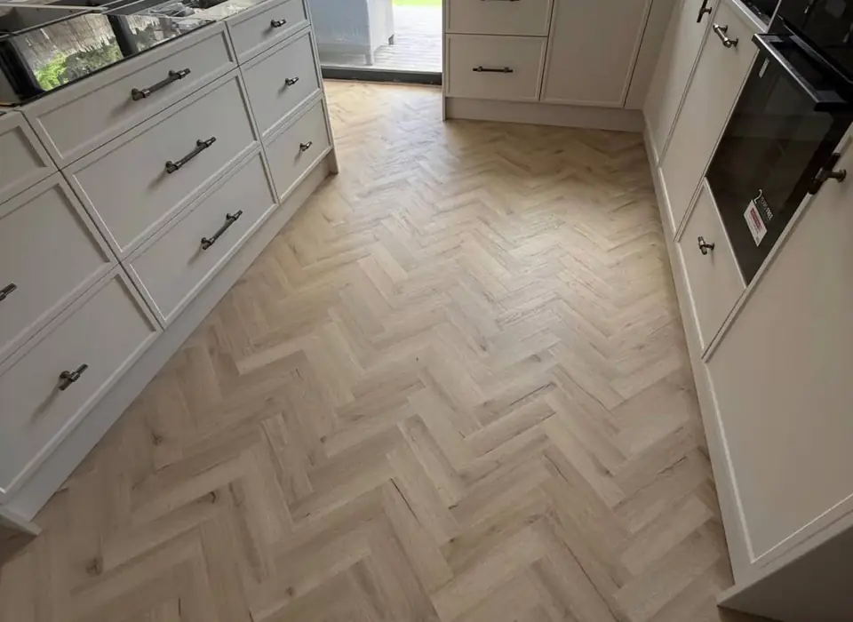 Herringbone floor between cream Shaker kitchen units