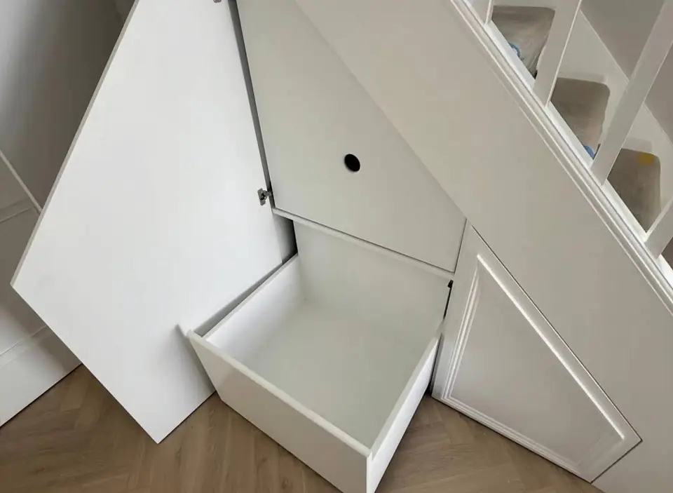 Under-stairs cupboard with a pull-out drawer open