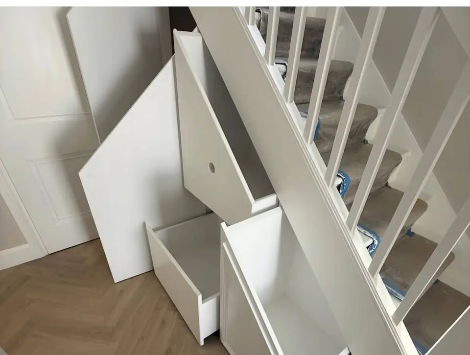 Under-stairs storage with two pull-out drawers open