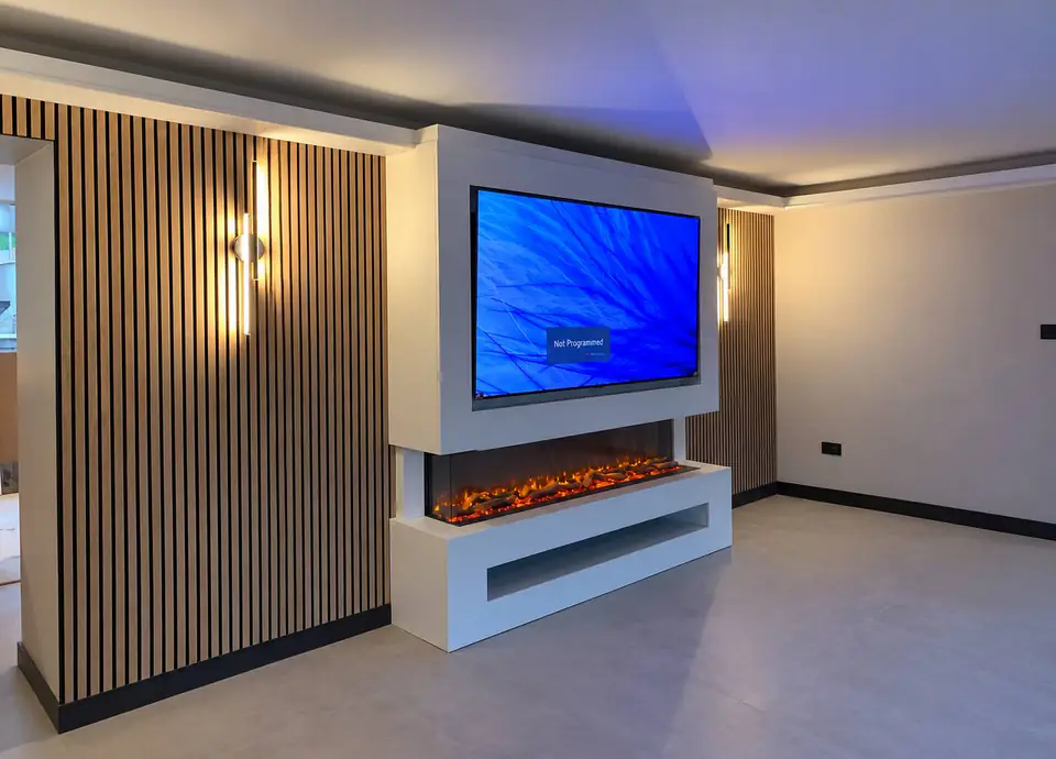 Media wall with a TV above an electric fire, slatted timber panels and wall lights