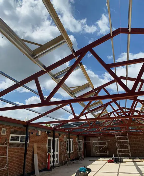 Steel roof trusses and glazing seen from below, London project