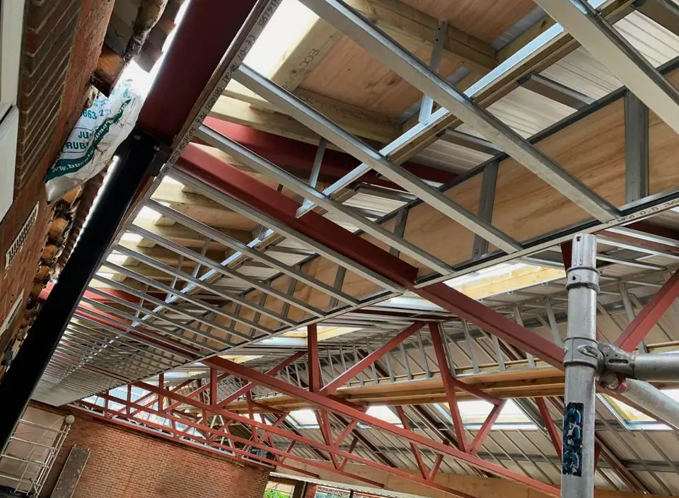 Steel beams and bracing beneath a roof, London project