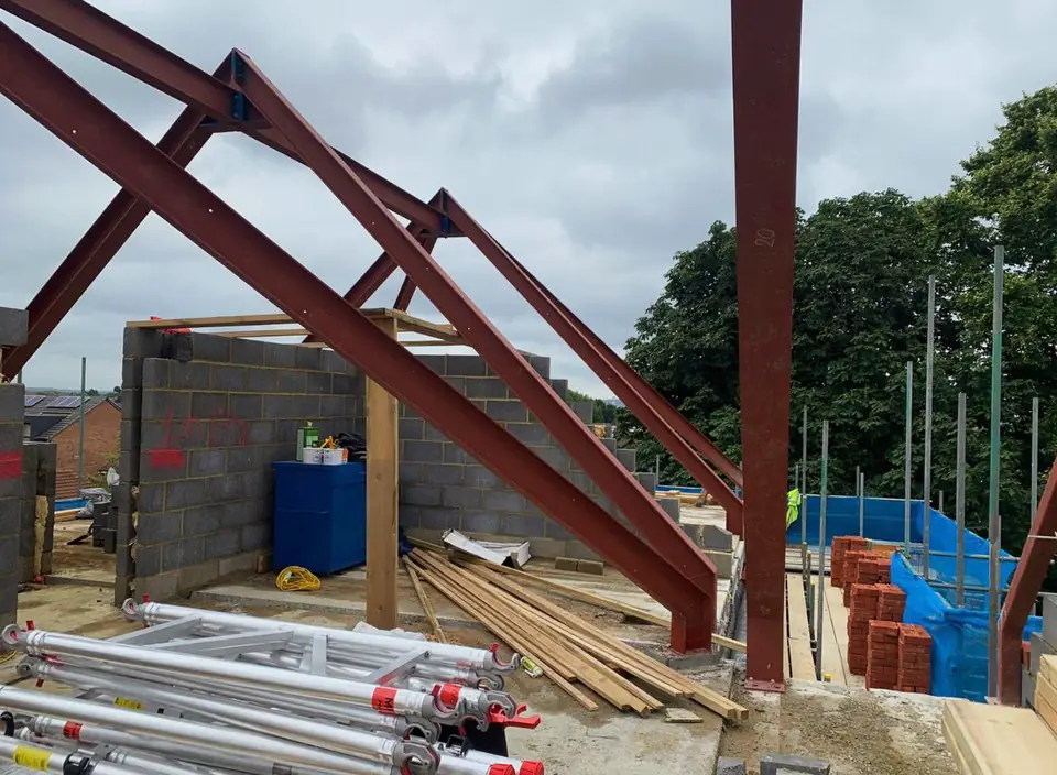 Steel portal frame with timber framing on a building site, London project