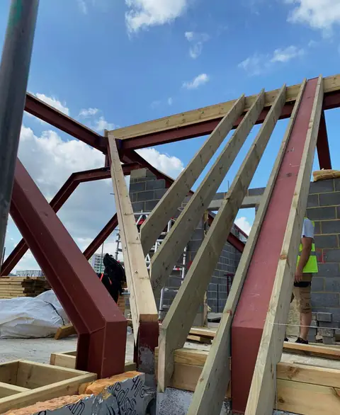 Timber rafters against a steel beam on a new roof, London project